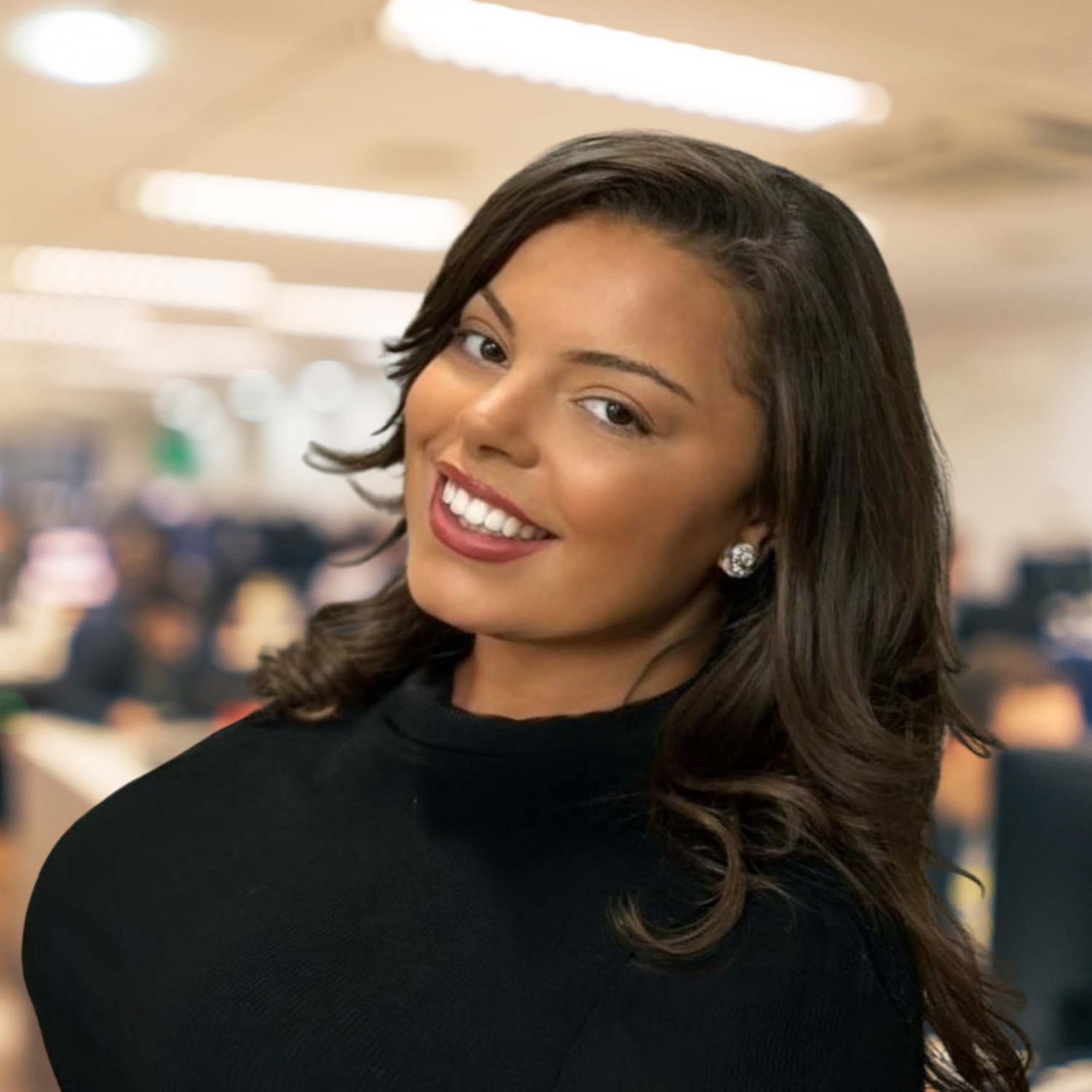 A shoulder length photo of a woman wearing black and smiling