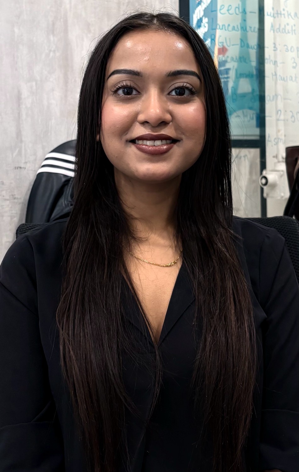 A South Asian woman in black