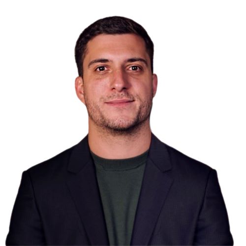 A professional headshot of Pierre wearing a black blazer against a white background