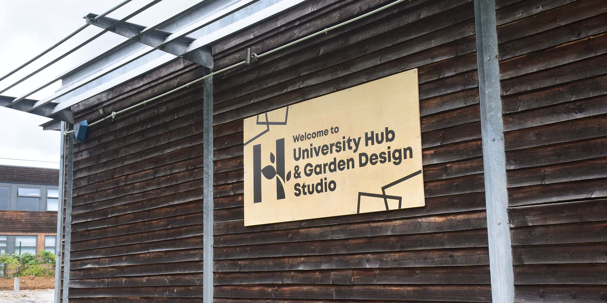 Hadlow University Hub signage on a building