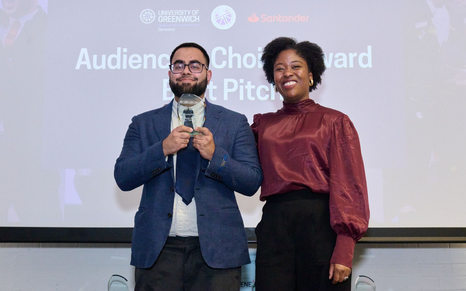 student on stage collecting award