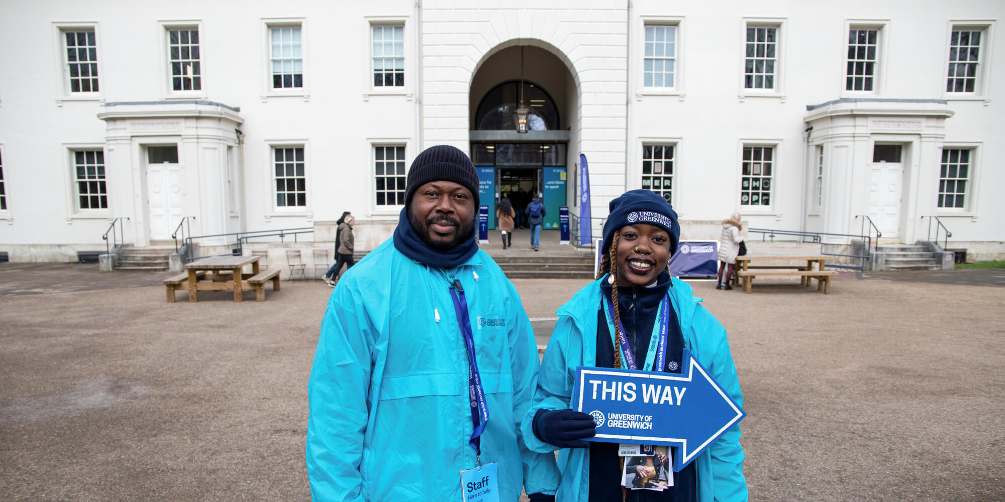 Image of two student ambassadors helping on an Open Day, outside dreadnought building in Greenwich.