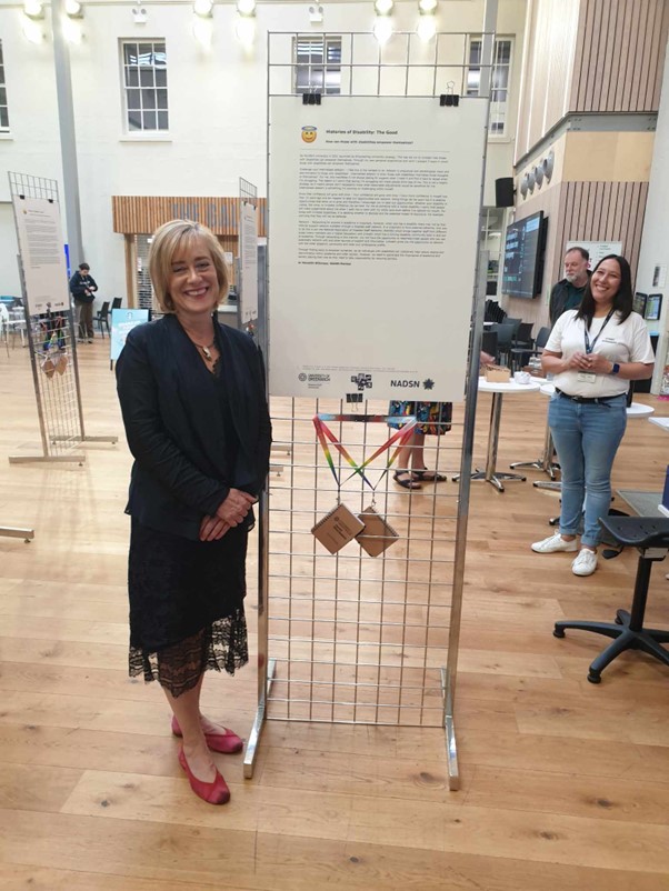 Jane Harrington standing next to one of the exhibits