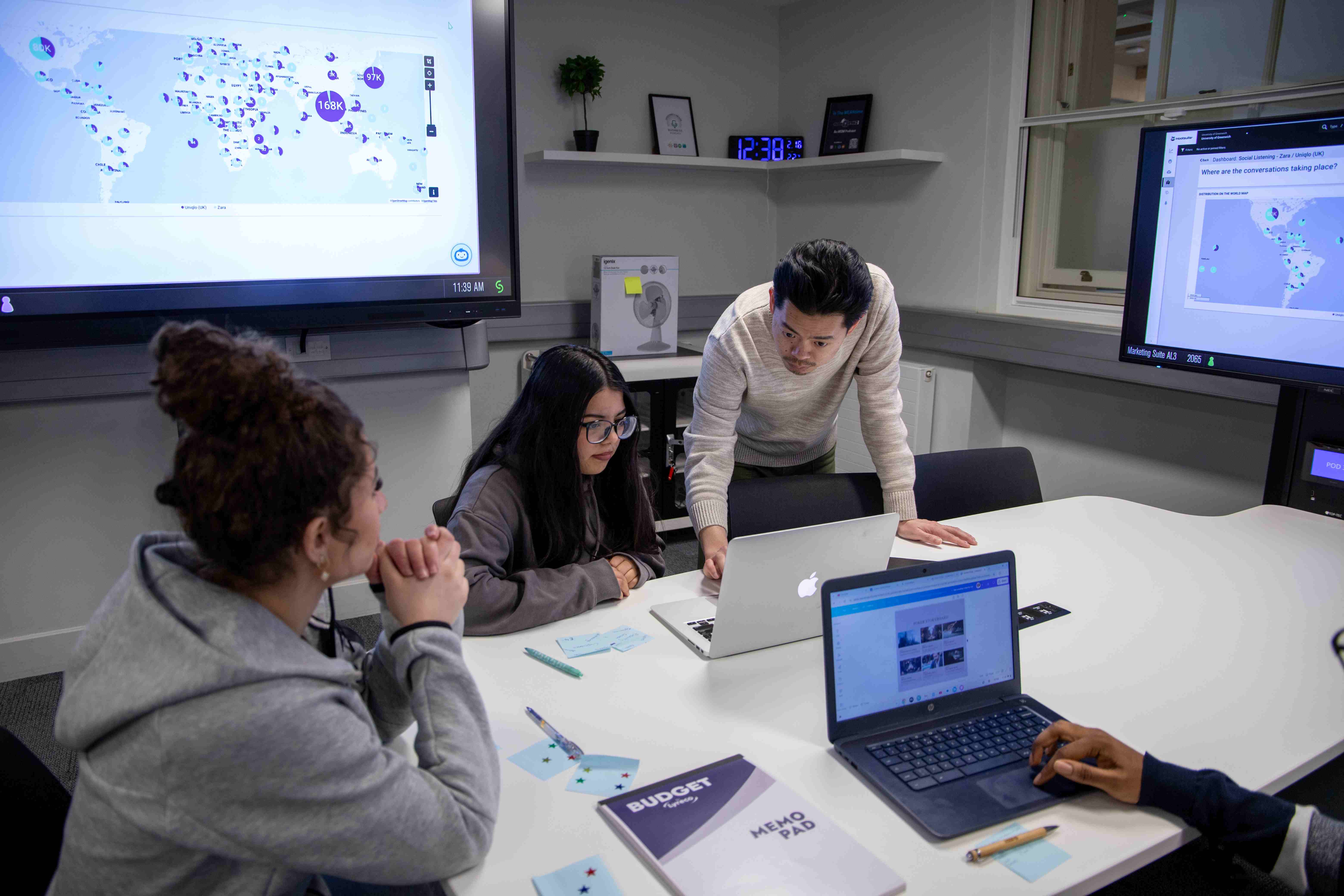 Four students using the Digital Marketing Suite