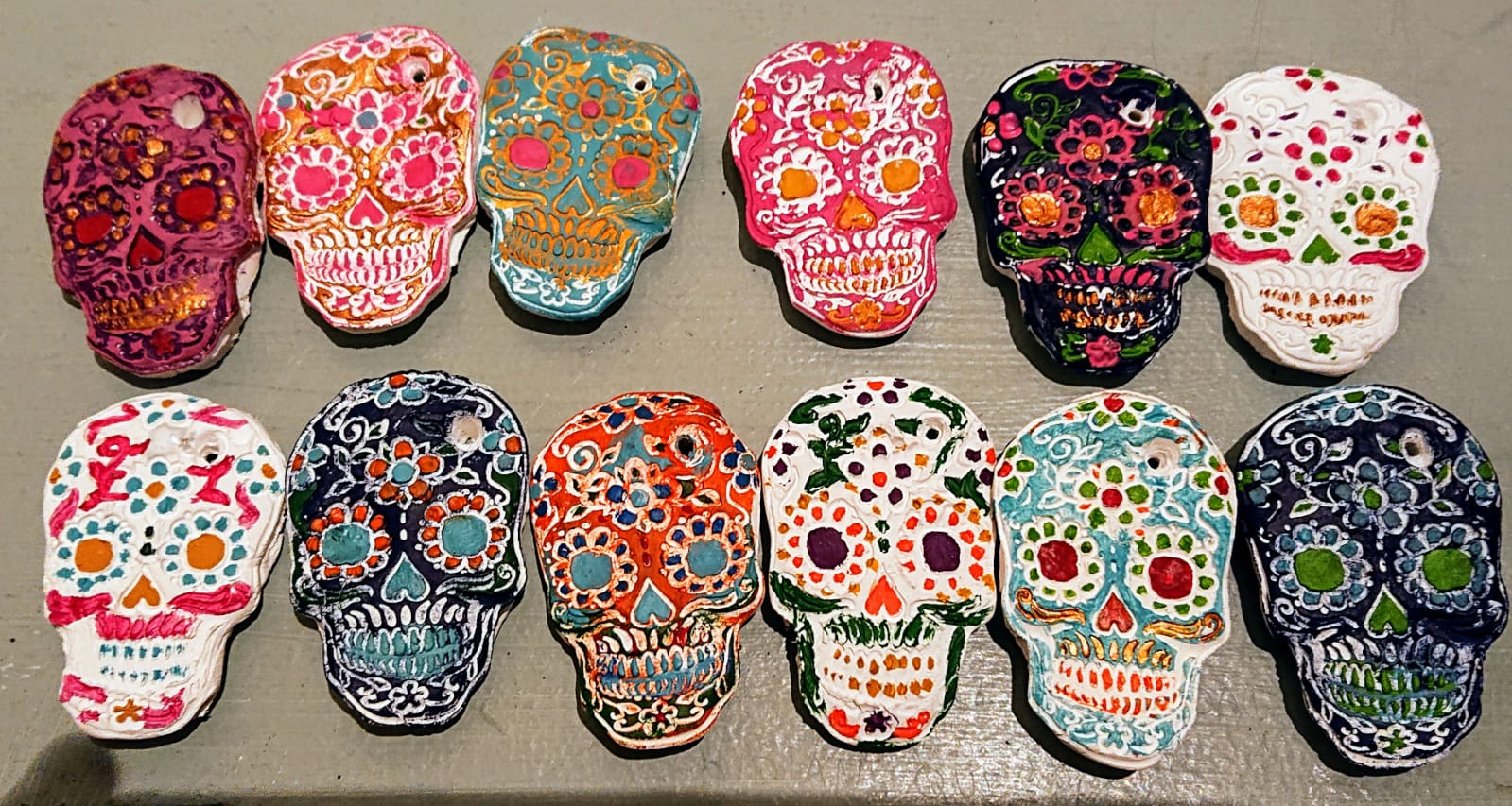A row of ceramic skulls have been painted in different patterns.