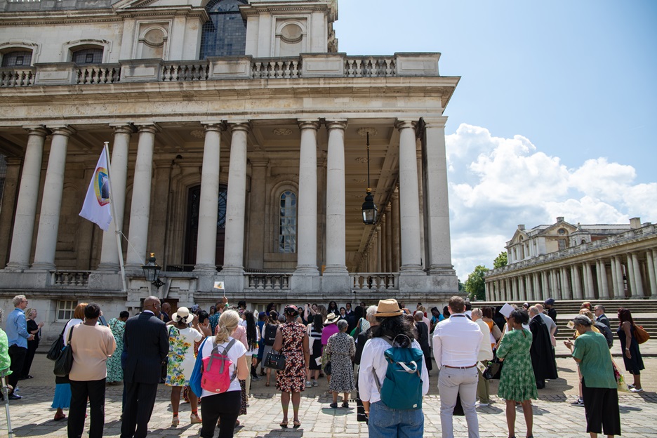 A crowd with the windrush flag