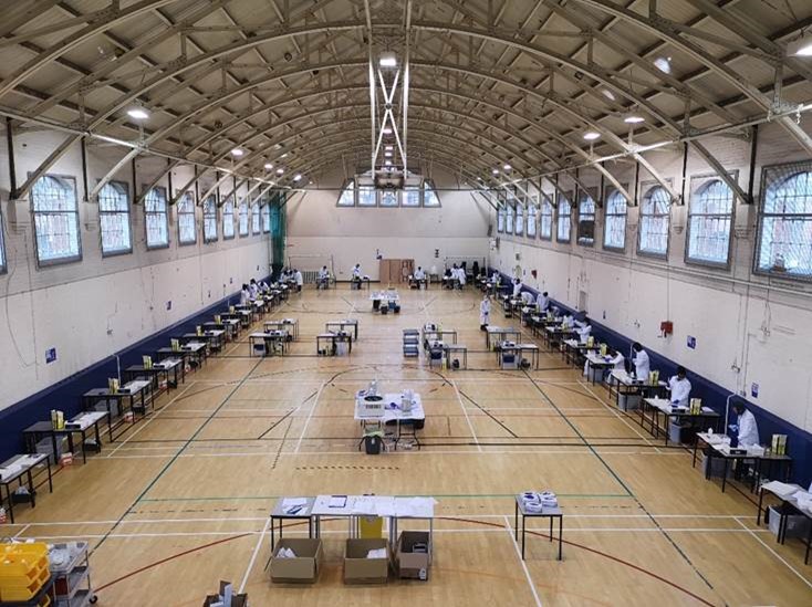 Indoor sport hall with tables arranged to form a laboratory