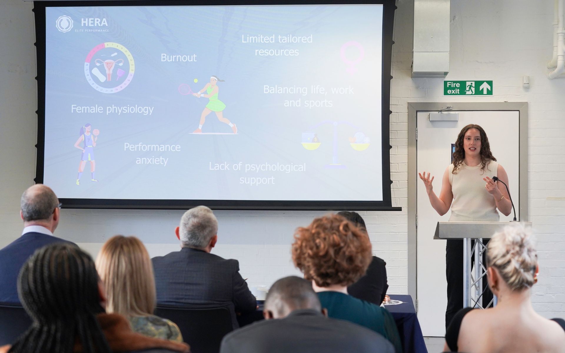 woman presenting to audience 