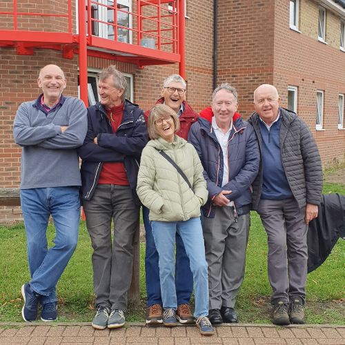 6 alumni smile at Avery Hill campus