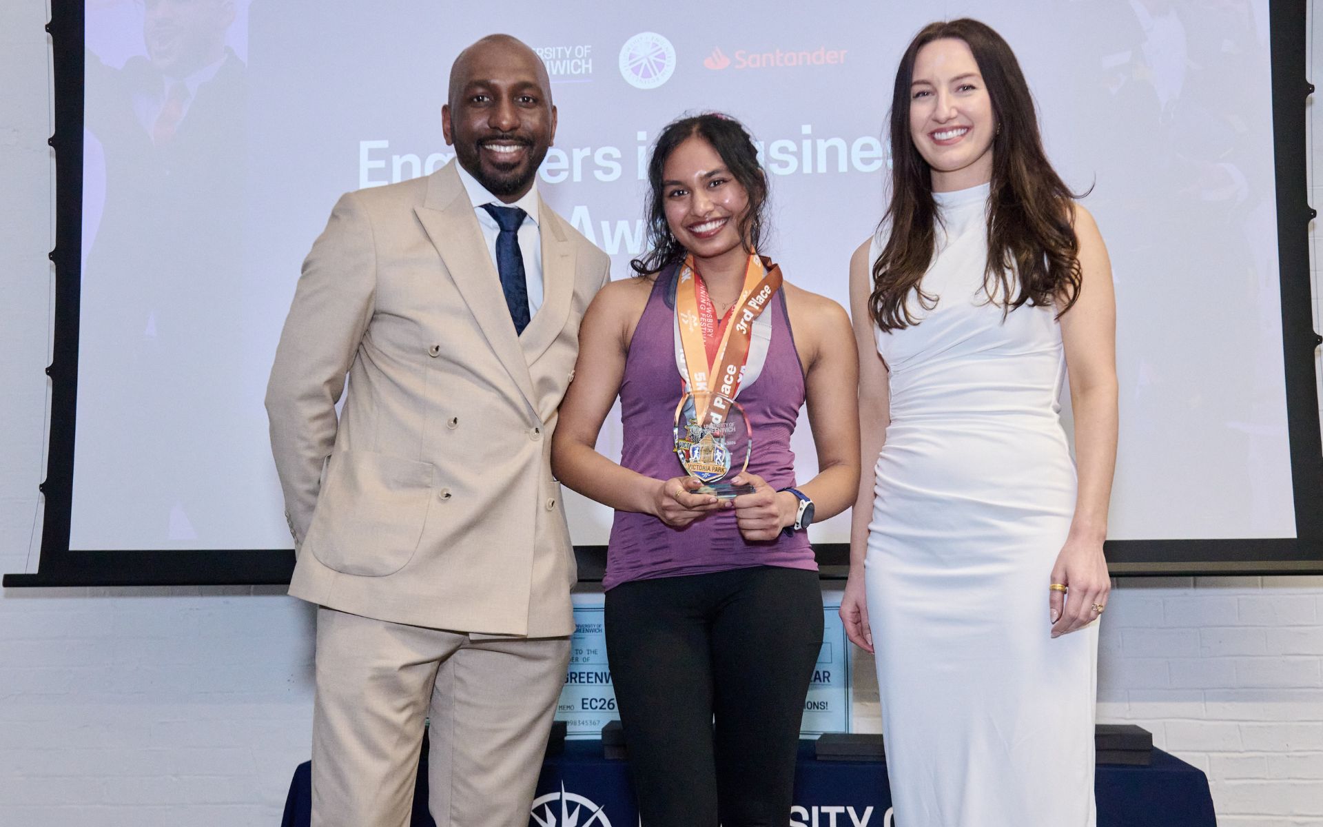 student on stage accepting award
