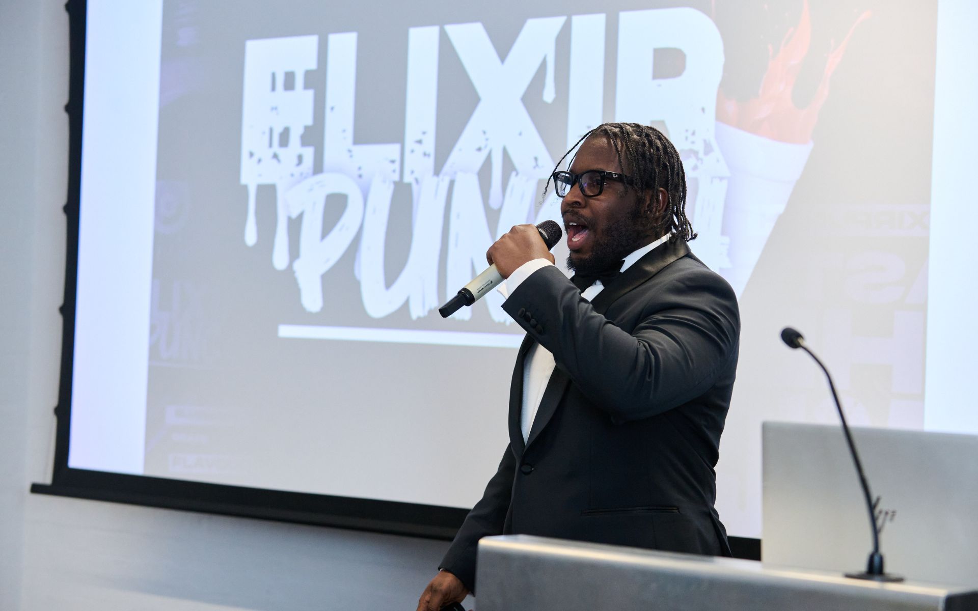 man on stage presenting