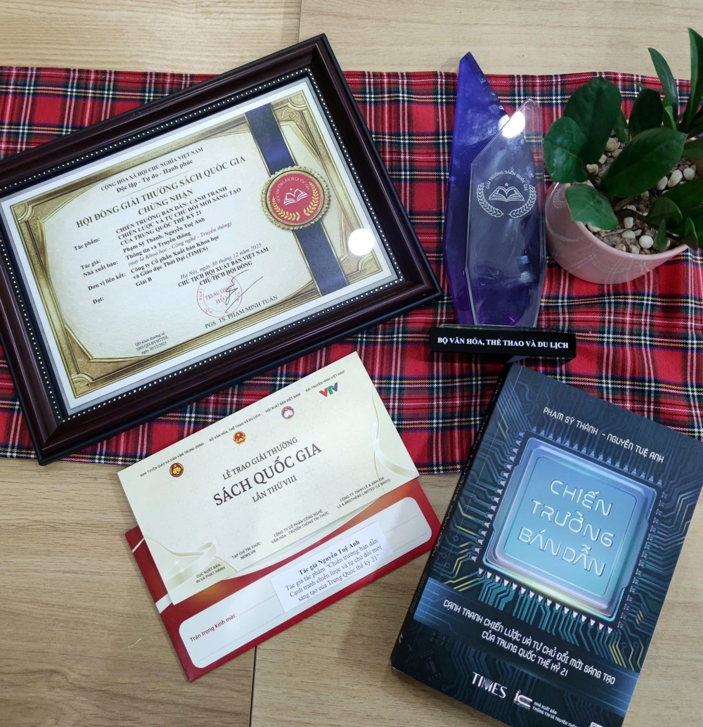 Presentation of items including award, certificate, and the book Chip Battlefield which won Vietnam’s National Book Award